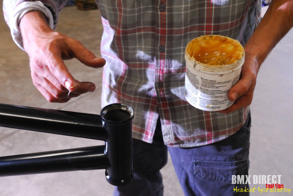 Apply a dab of grease to the angled bearing facings on both the top and bottom of the headtube. Smear it round lightly covering it evenly and throughly.